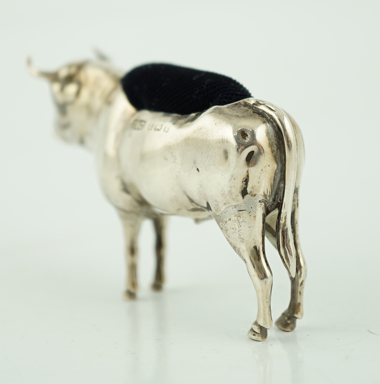 An Edwardian novelty silver pin cushion, modelled as a bull, Cohen & Charles